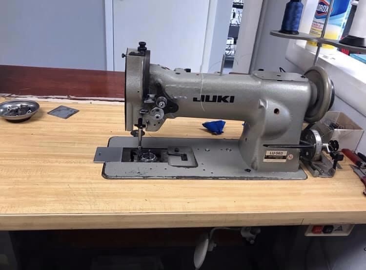 Industrial sewing machine backstitch repair and fabric feed dog adjustment